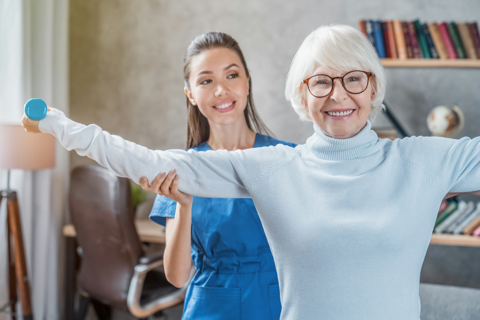 Senior woman training with physiotherapist at home