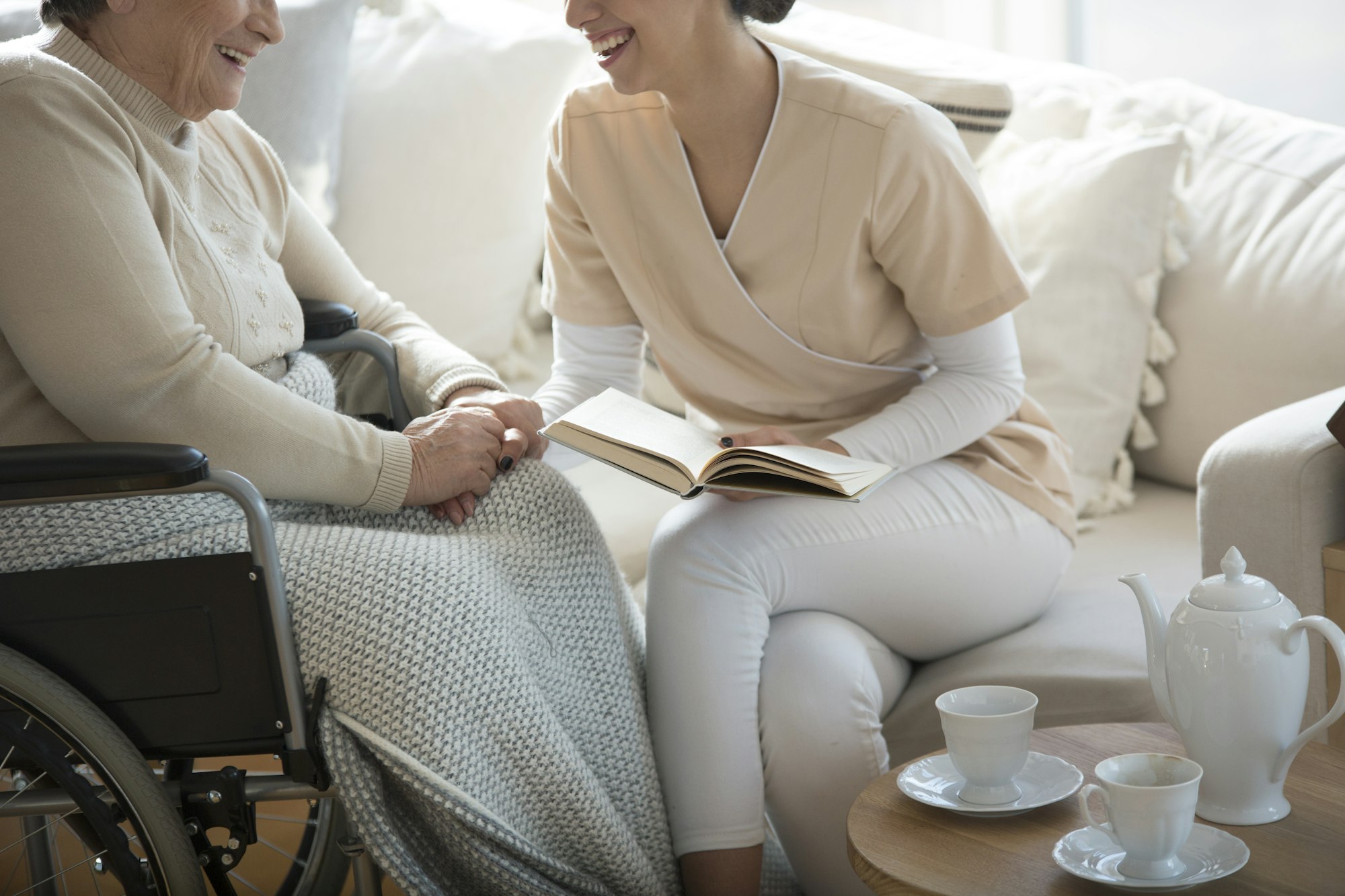 Woman assisting patient in wheelchair